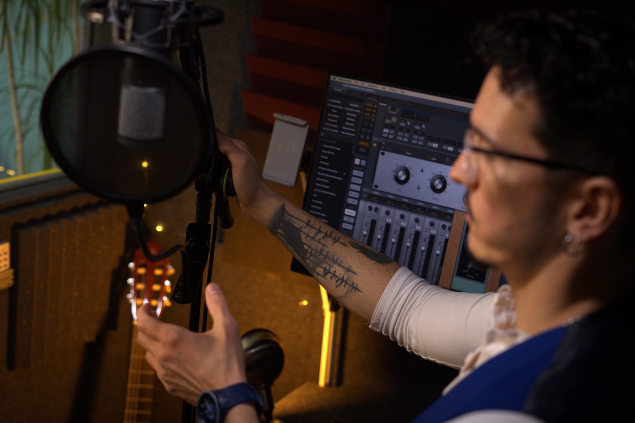 Edward adjusting a microphone in the vocal booth